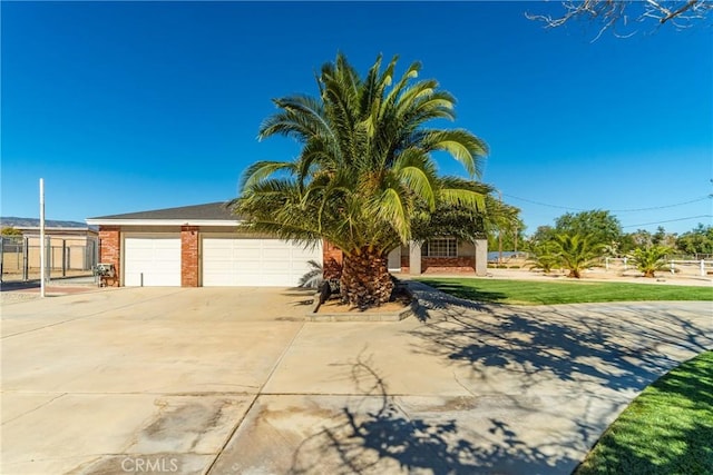 view of property hidden behind natural elements featuring a garage