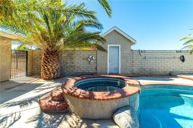 view of swimming pool with an in ground hot tub