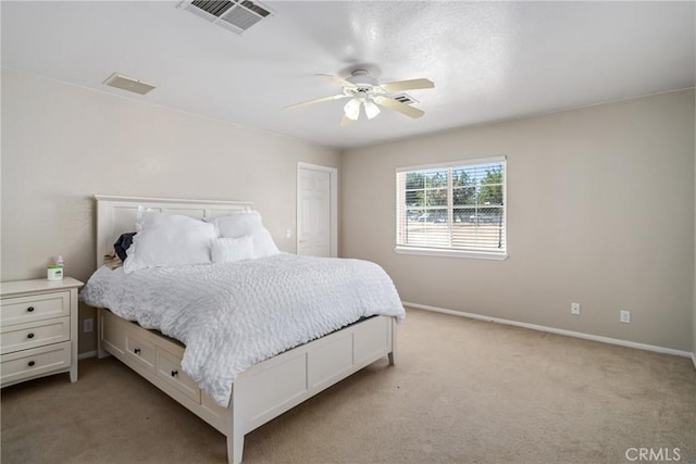 bedroom with ceiling fan and light colored carpet