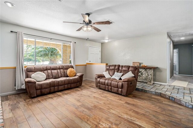 living room featuring hardwood / wood-style flooring and ceiling fan