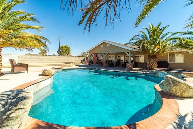 view of pool with an in ground hot tub and a patio