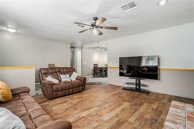 living room with ceiling fan and hardwood / wood-style flooring