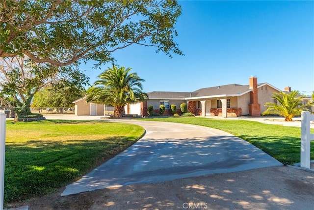 ranch-style house with a garage and a front lawn