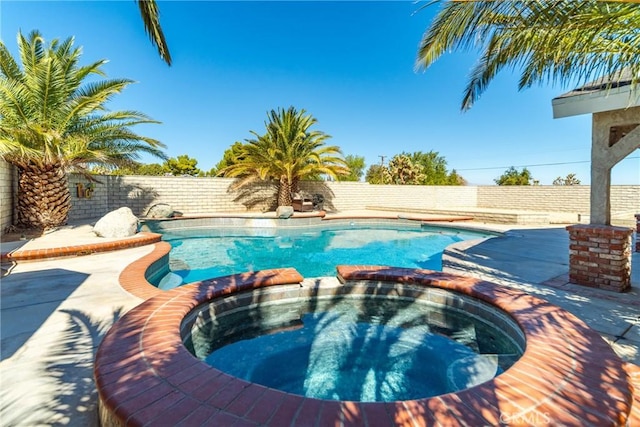 view of swimming pool with an in ground hot tub and a patio