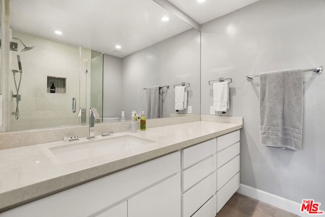 bathroom featuring walk in shower and vanity