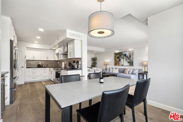 dining space with hardwood / wood-style floors