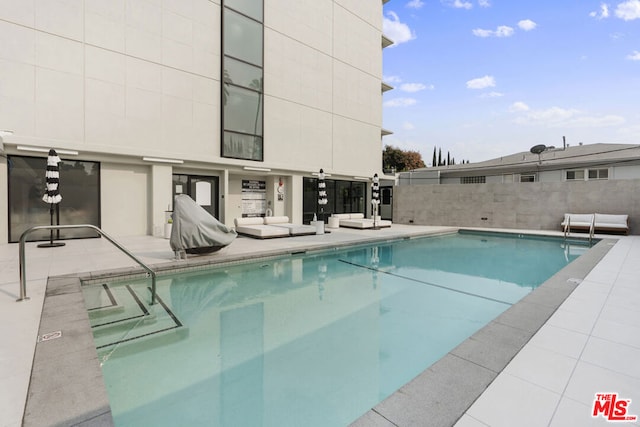 view of swimming pool with a patio area