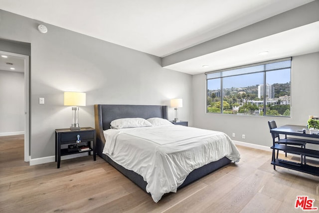 bedroom with hardwood / wood-style flooring