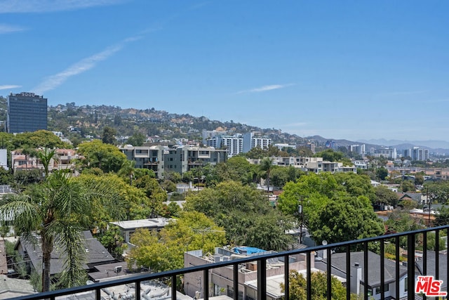 property's view of city featuring a mountain view