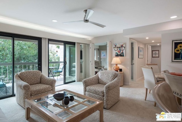 living room featuring light carpet and ceiling fan