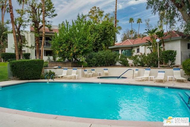 view of pool featuring a patio area and a community hot tub