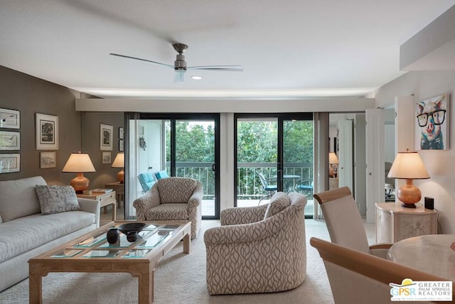 carpeted living room featuring ceiling fan