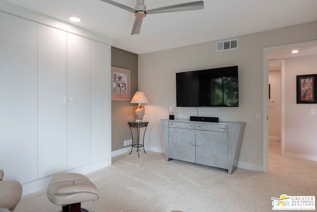 living room with light carpet and ceiling fan