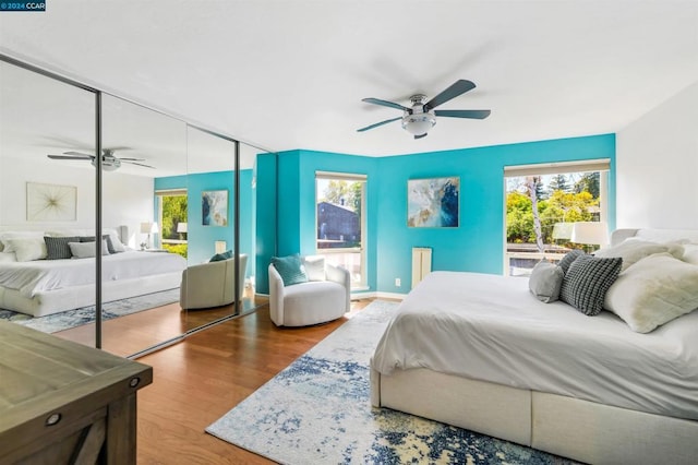 bedroom with ceiling fan, a closet, and wood-type flooring