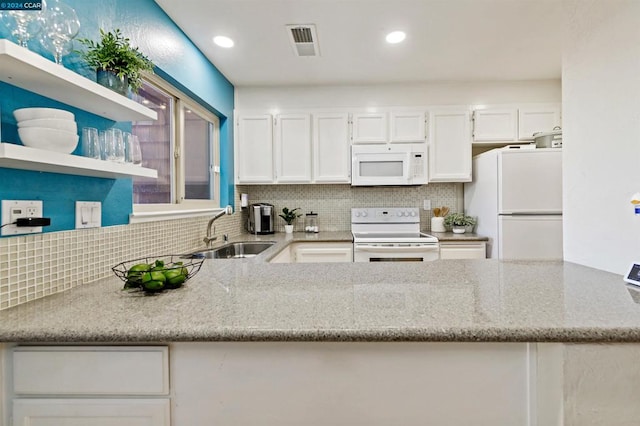 kitchen featuring light stone counters, sink, tasteful backsplash, white appliances, and white cabinetry