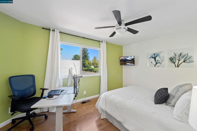 bedroom with hardwood / wood-style floors and ceiling fan