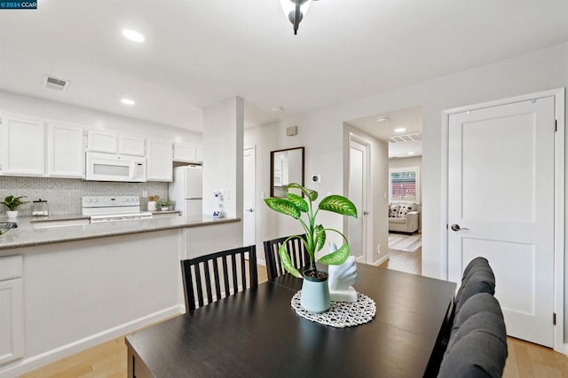 dining area with light wood-type flooring