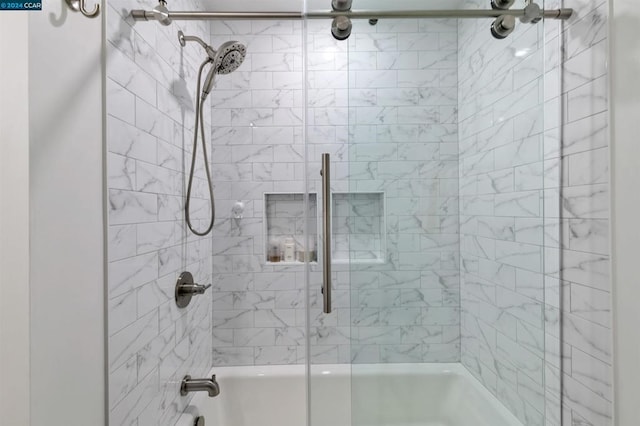 bathroom featuring combined bath / shower with glass door