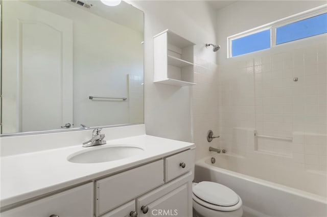 full bathroom featuring toilet, vanity, and  shower combination