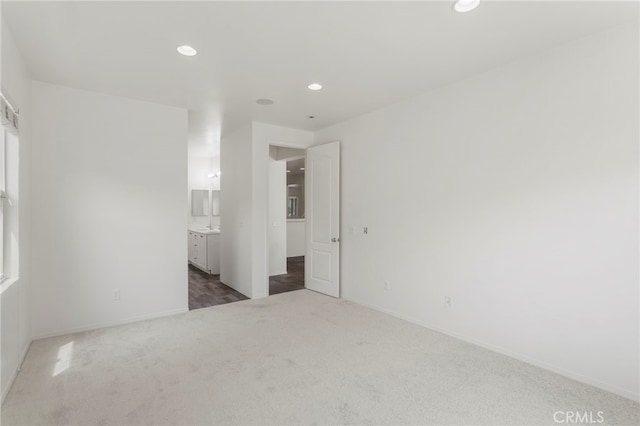 unfurnished room with dark colored carpet