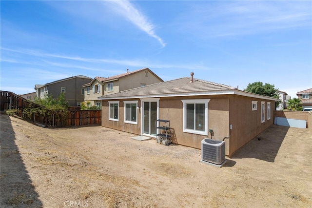 rear view of house featuring central AC unit