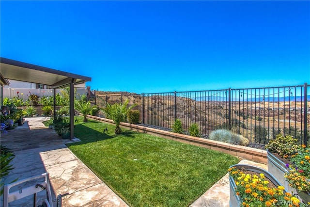 view of yard with a patio area and a water view