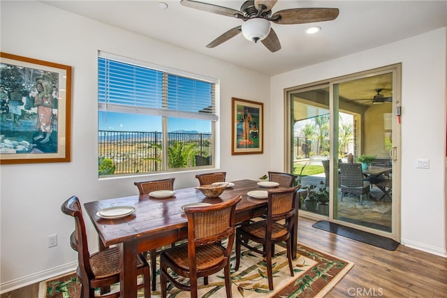 dining space with wood-type flooring and ceiling fan