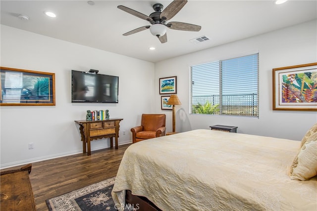 bedroom with dark hardwood / wood-style floors and ceiling fan