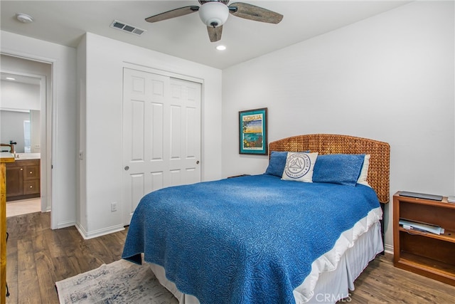 bedroom featuring a closet, dark wood-type flooring, and ceiling fan