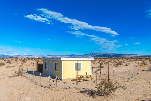 rear view of property featuring a mountain view