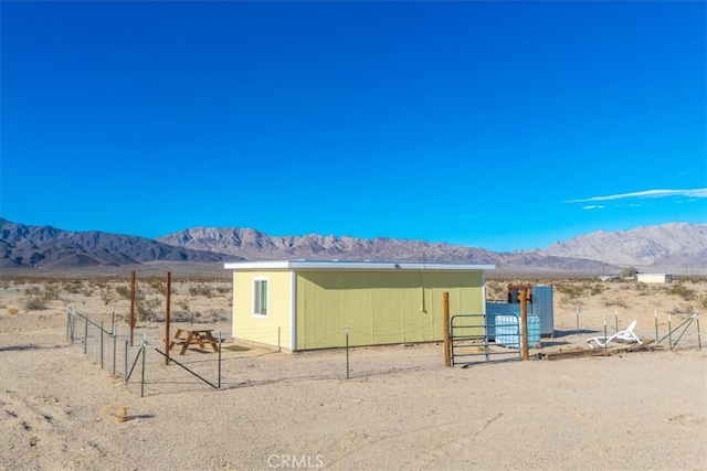 exterior space featuring a mountain view, an outbuilding, and a rural view