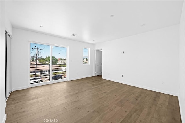 empty room with wood-type flooring