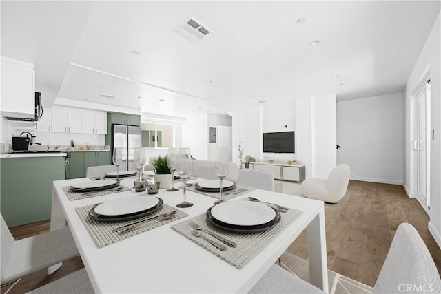 dining area featuring a wealth of natural light and light hardwood / wood-style floors