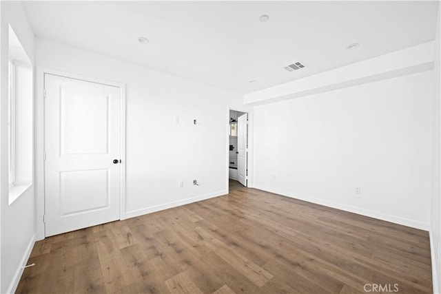 spare room with hardwood / wood-style floors