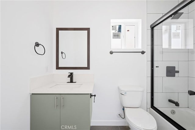 full bathroom with tile patterned flooring, combined bath / shower with glass door, toilet, and vanity