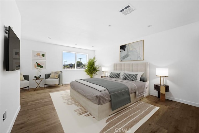 bedroom with dark wood-type flooring