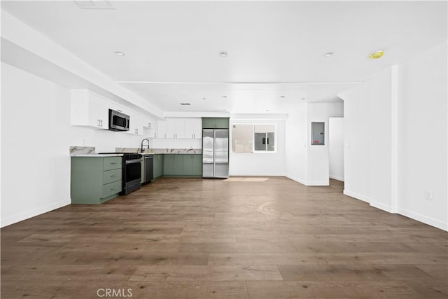 unfurnished living room featuring hardwood / wood-style flooring and sink