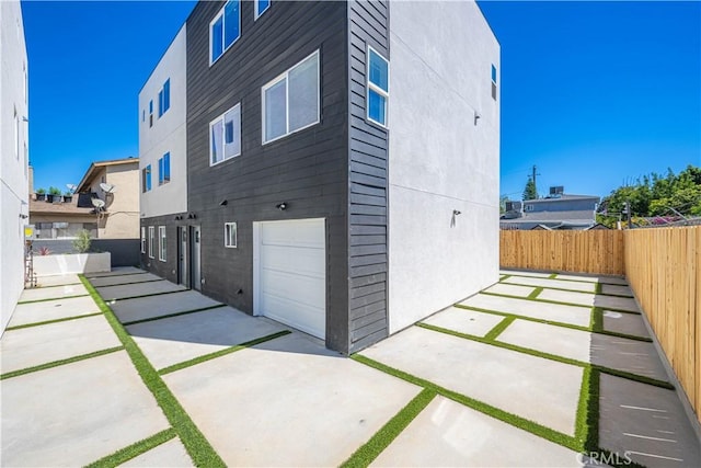 view of side of property with a garage