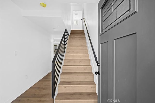 stairway featuring hardwood / wood-style floors