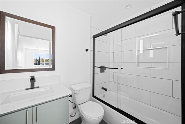 full bathroom with vanity, enclosed tub / shower combo, and toilet