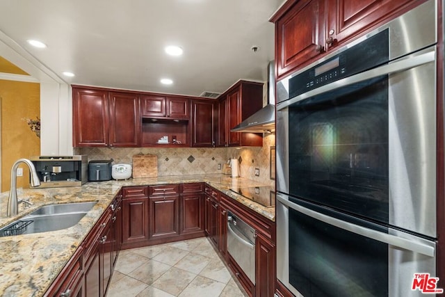 kitchen featuring black electric cooktop, decorative backsplash, light stone counters, stainless steel double oven, and sink