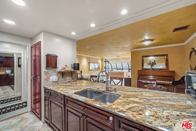 kitchen featuring light tile patterned floors, ornamental molding, sink, tasteful backsplash, and light stone countertops