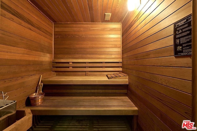 view of sauna / steam room featuring wood walls and wooden ceiling