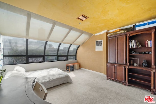 carpeted bedroom with lofted ceiling