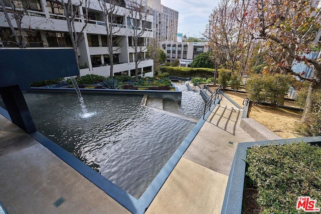 view of swimming pool featuring a water view