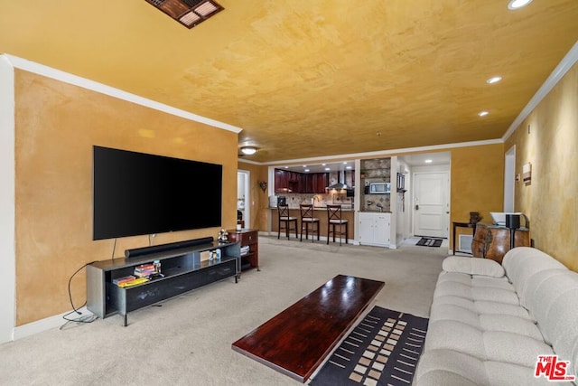 living room with carpet flooring and ornamental molding