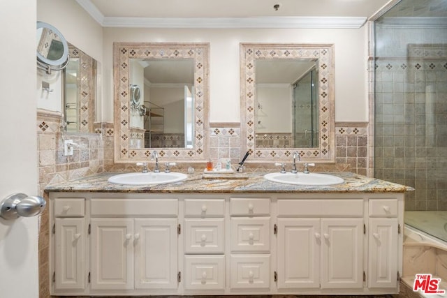 bathroom featuring crown molding, a shower, vanity, and tile walls