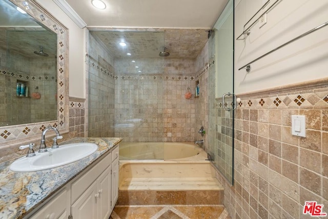 bathroom with enclosed tub / shower combo, vanity, tile walls, and ornamental molding