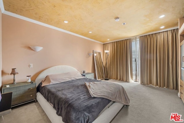 carpeted bedroom featuring crown molding