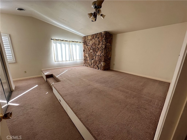 unfurnished living room featuring carpet floors and lofted ceiling